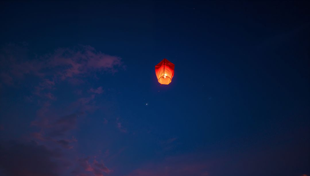Solitary Red Sky Lantern Soaring in Twilight Serenity