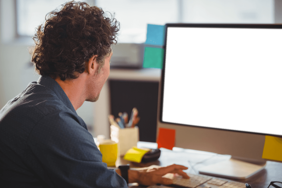 Transparent office workspace with businessman at computer