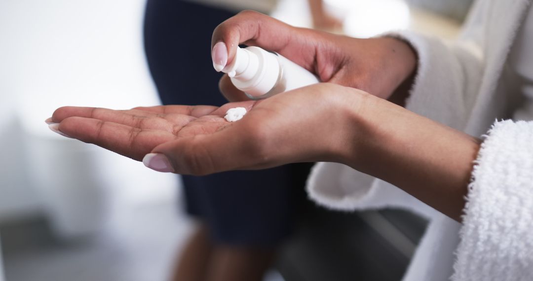 Close-up of Hands Applying Moisturizing Lotion at Home