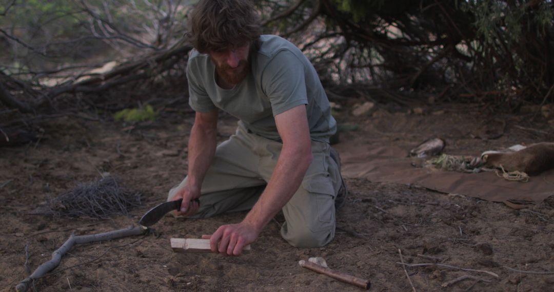 Man Using Survival Skills in Woods with Knife and Firestarter - Free Images, Stock Photos and Pictures on Pikwizard.com