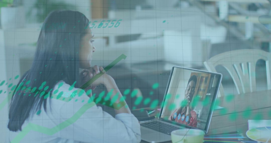 Businesswoman in Virtual Meeting with Overlaid Financial Data Graphics