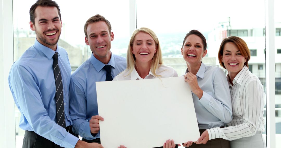 Group of Smiling Business Professionals Holding a Blank Signboard - Free Images, Stock Photos and Pictures on Pikwizard.com