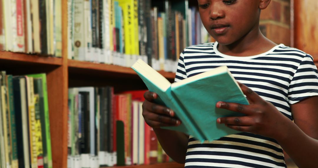 Young girl reading a book in library - Free Images, Stock Photos and Pictures on Pikwizard.com