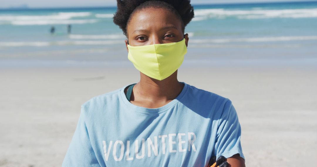 Portrait of african american woman wearing volunteer t shirt and face mask looking at camera - Free Images, Stock Photos and Pictures on Pikwizard.com