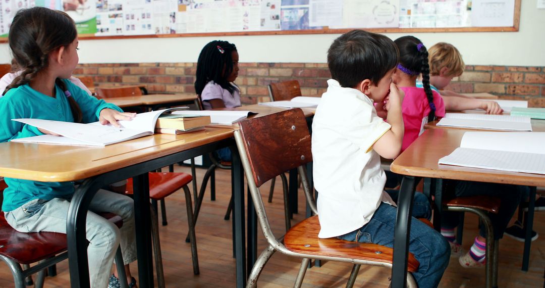 Children in Classroom Sitting at Desks Studying - Free Images, Stock Photos and Pictures on Pikwizard.com