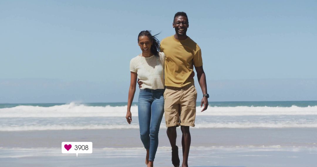 Smiling couple walking on beach embracing at shoreline with waves and like badge