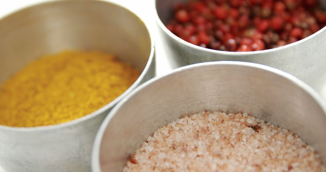 Close-Up of Colorful Spices in Metal Containers on White Background - Free Images, Stock Photos and Pictures on Pikwizard.com