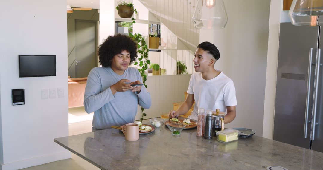 Two Friends Preparing Breakfast with Avocado Toast in Modern Kitchen