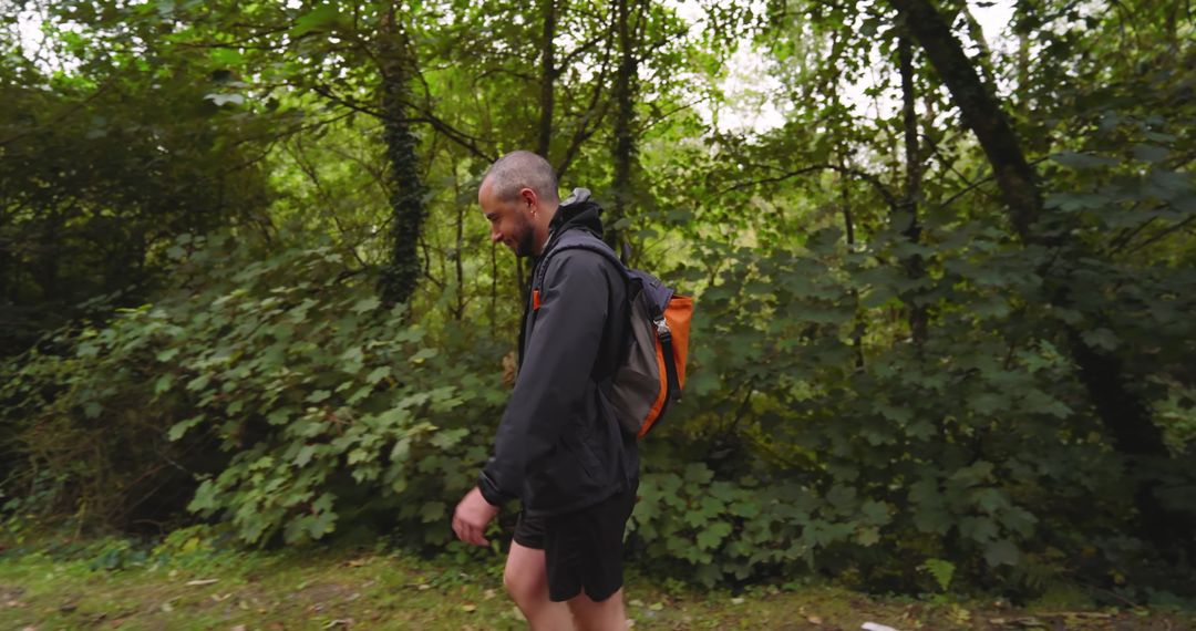 Man Walking Through Forest on Hiking Adventure