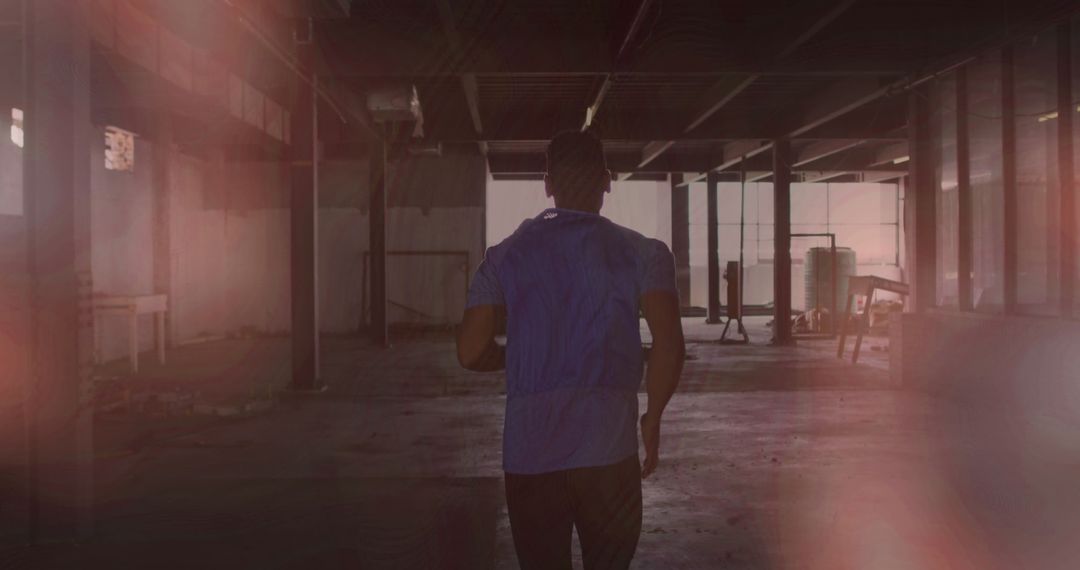 Man Jogging in Abandoned Building with Intriguing Light Effects