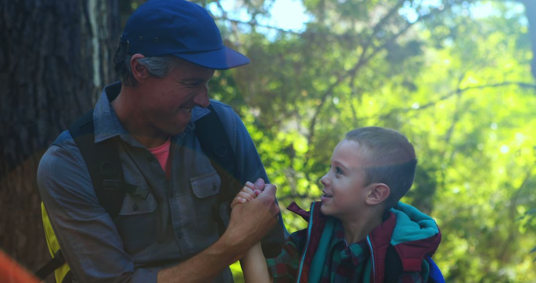 Smiling Father and Son Enjoying Hike in Forest - Free Images, Stock Photos and Pictures on Pikwizard.com