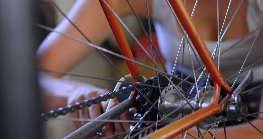 Man fixing bicycle wheel with tools and chain adjustments - Free Images, Stock Photos and Pictures on Pikwizard.com