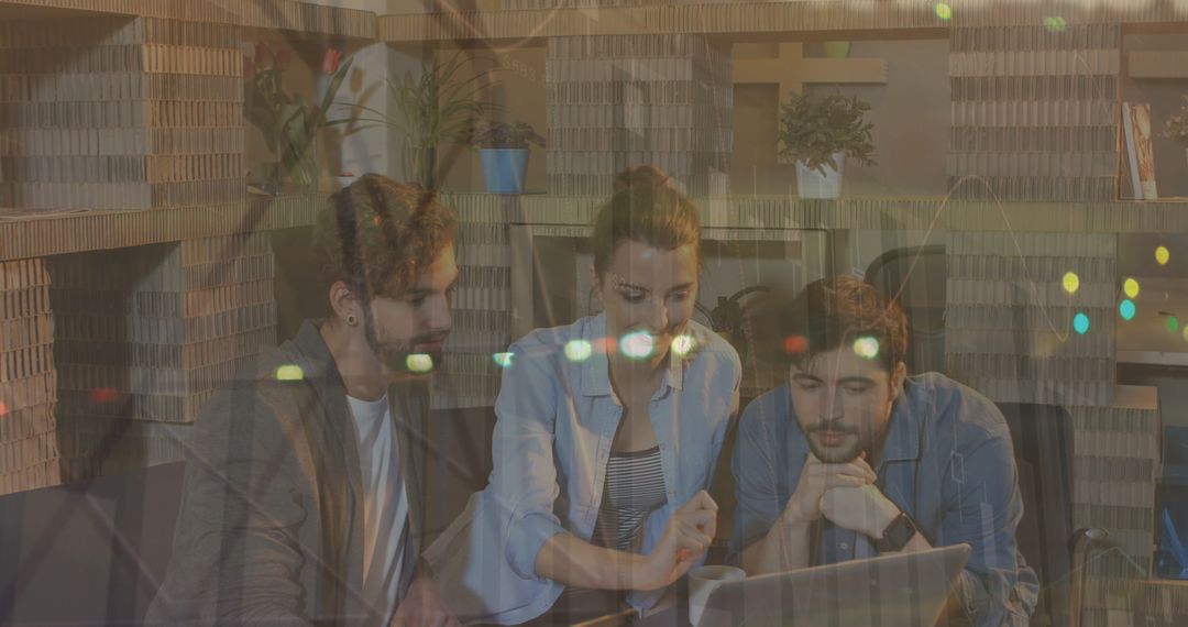 Young Professionals Collaborating on Laptop for Data Analysis