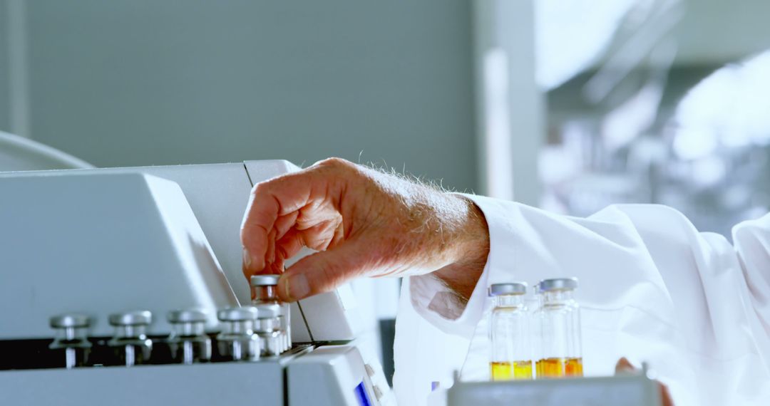 Scientist in lab coat handling vials in laboratory - Free Images, Stock Photos and Pictures on Pikwizard.com