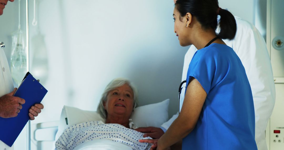 Nurse and Doctor Attending to Senior Patient in Hospital Bed - Free Images, Stock Photos and Pictures on Pikwizard.com