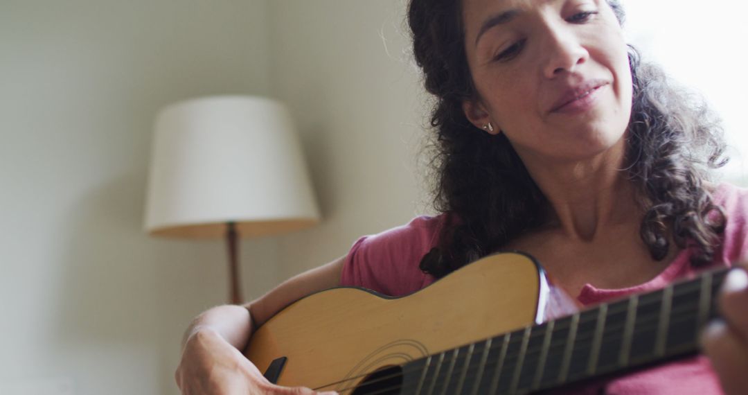 Woman Playing Acoustic Guitar in Cozy Living Room - Free Images, Stock Photos and Pictures on Pikwizard.com