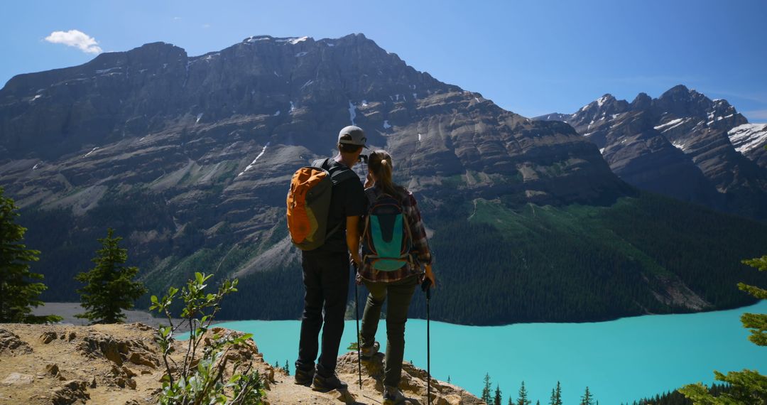 Couple Hiking on Mountain Trail Overlooking Scenic Lake and Peaks - Free Images, Stock Photos and Pictures on Pikwizard.com