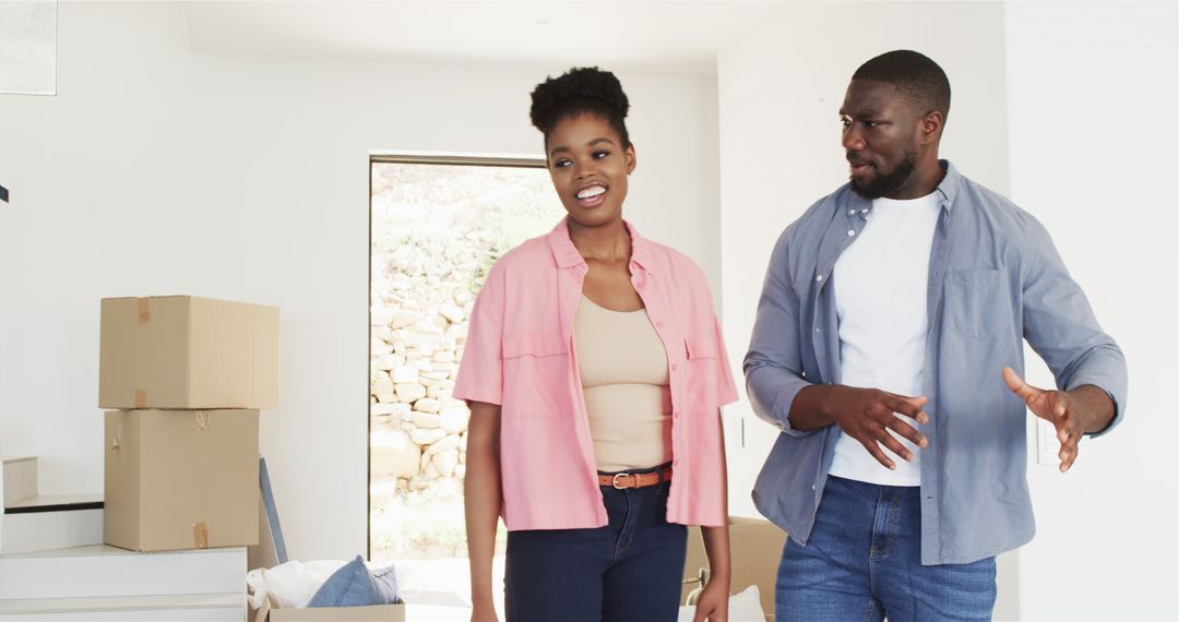 Happy Couple Embracing House Move with Cardboard Boxes