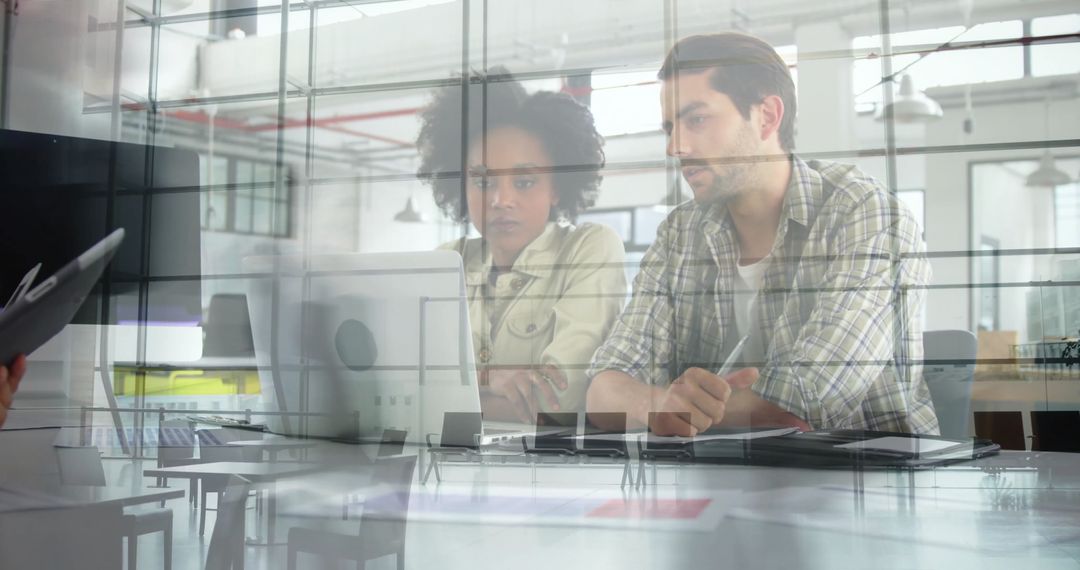 Modern Office Team Reflected in Glass Analyzing Data on Laptop