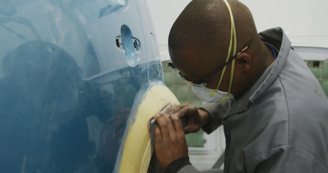 Mechanic Repairing Car Bodywork in Workshop Setting - Free Images, Stock Photos and Pictures on Pikwizard.com