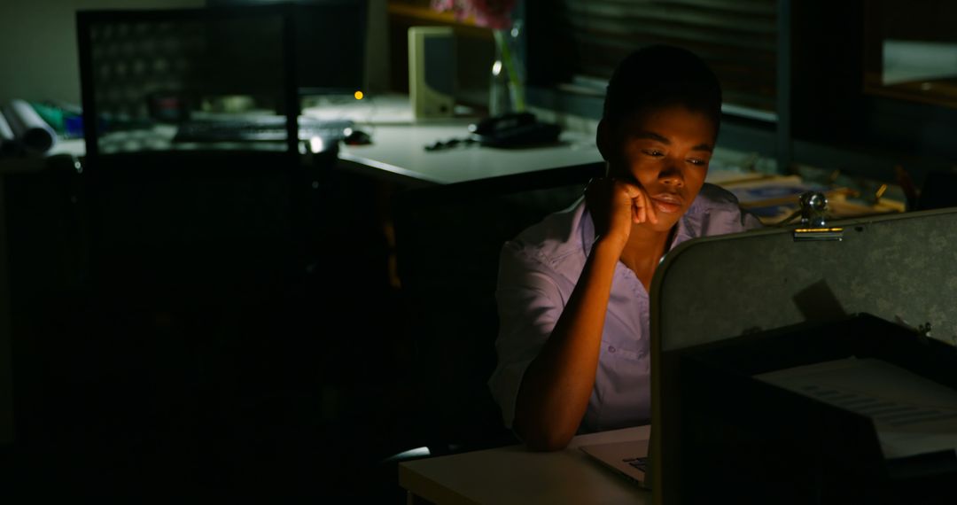 Businesswoman Working Late on Laptop in Dark Office - Free Images, Stock Photos and Pictures on Pikwizard.com