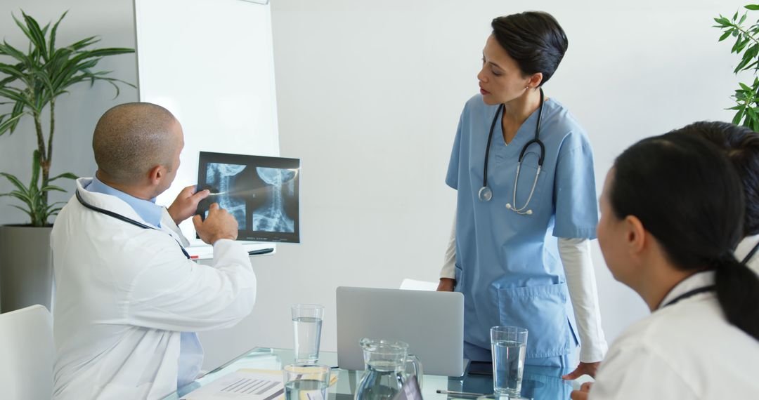 Medical Team Discussing X-Ray in Meeting Room - Free Images, Stock Photos and Pictures on Pikwizard.com