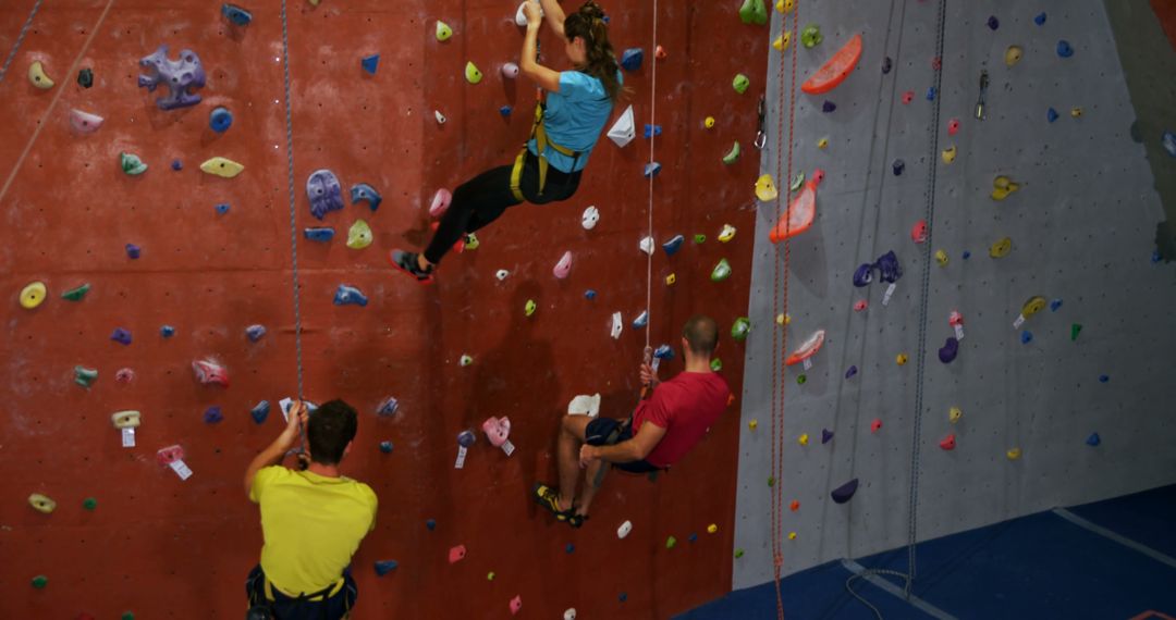 People Climbing Indoors on Rock Wall - Free Images, Stock Photos and Pictures on Pikwizard.com