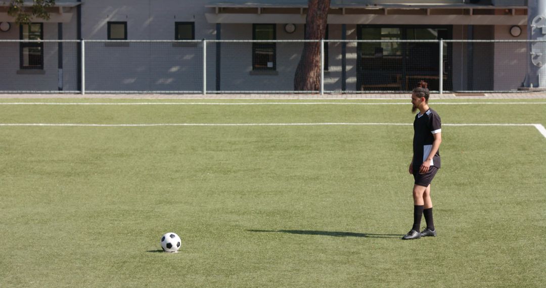 Teen Soccer Player Contemplating Strategy on Field