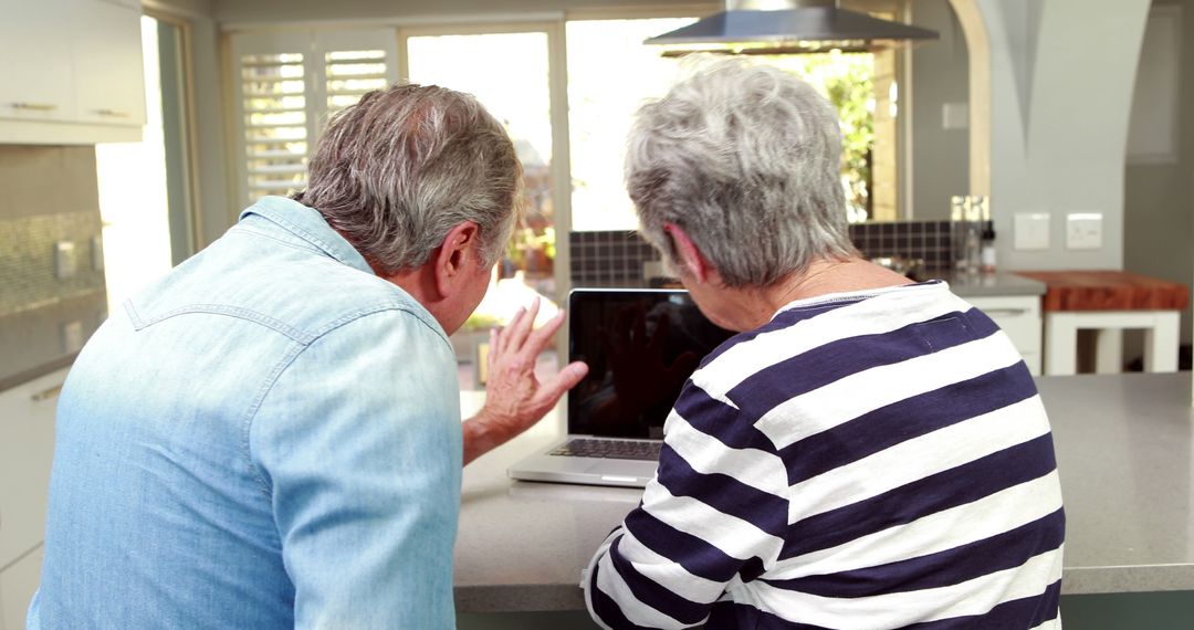 Senior Couple Engaging in Video Call on Laptop
