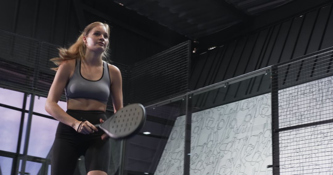 Female Athlete Playing Paddle Sport in Indoor Arena