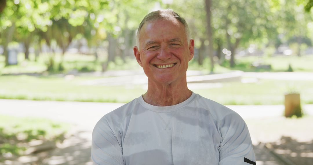 Portrait of happy senior caucasian man wearing gray tshirt in sunny park - Free Images, Stock Photos and Pictures on Pikwizard.com