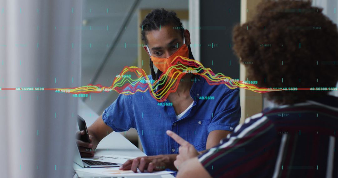 Diverse Business Team Analyzing Data with Masked Discussion in Office