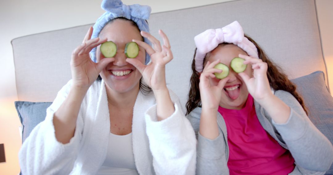 Mother and Daughter Enjoying Skincare Routine with Cucumber Slices - Free Images, Stock Photos and Pictures on Pikwizard.com