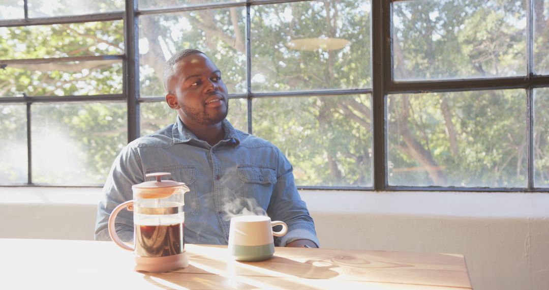 Man Relaxing with Coffee by Sunny Window at Home