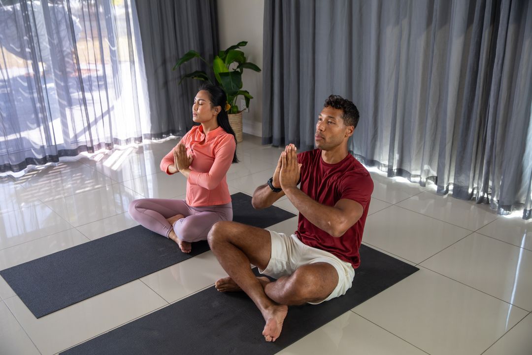 Diverse Friends Meditating in Home Yoga Session for Relaxation