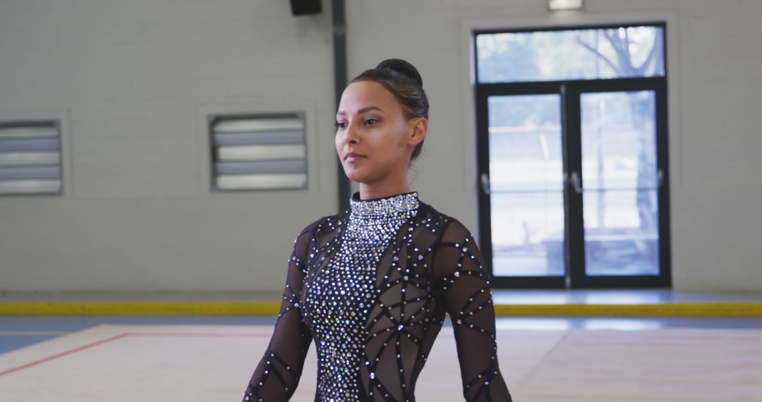 Focused Rhythmic Gymnast in Sparkling Black Costume at Practice Hall - Free Images, Stock Photos and Pictures on Pikwizard.com