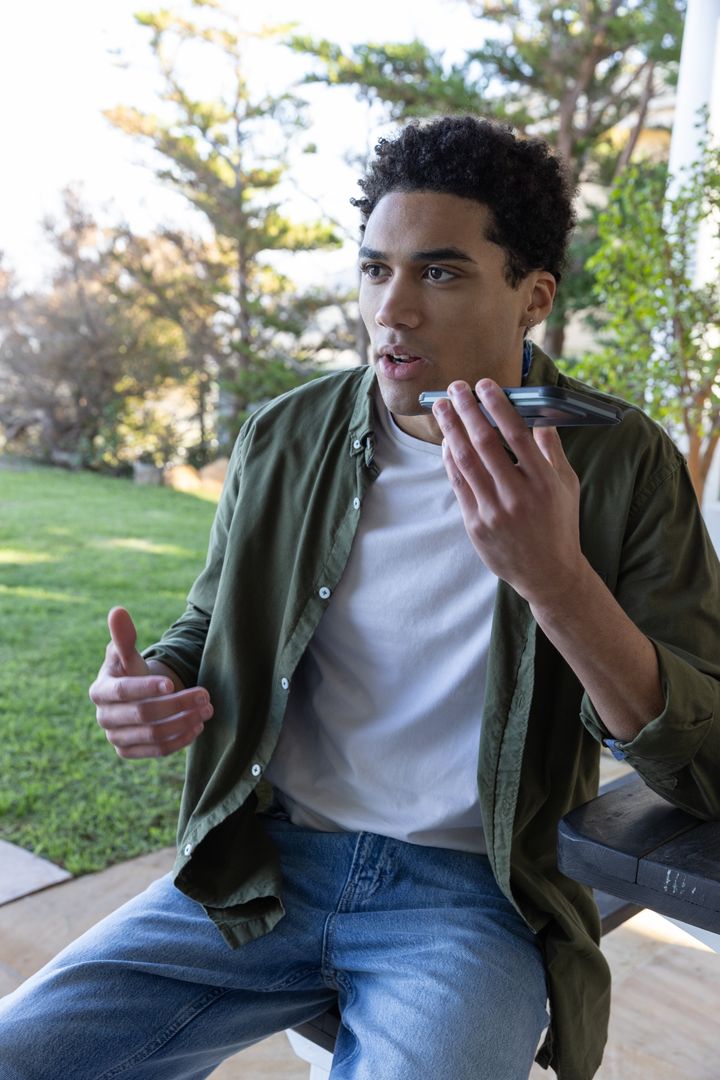 Man on Patio Engaging in Hands-Free Phone Call
