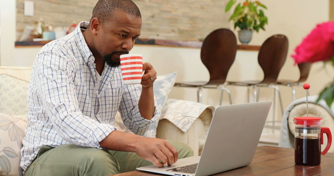 Man Enjoying Coffee While Working Remotely on Laptop - Free Images, Stock Photos and Pictures on Pikwizard.com