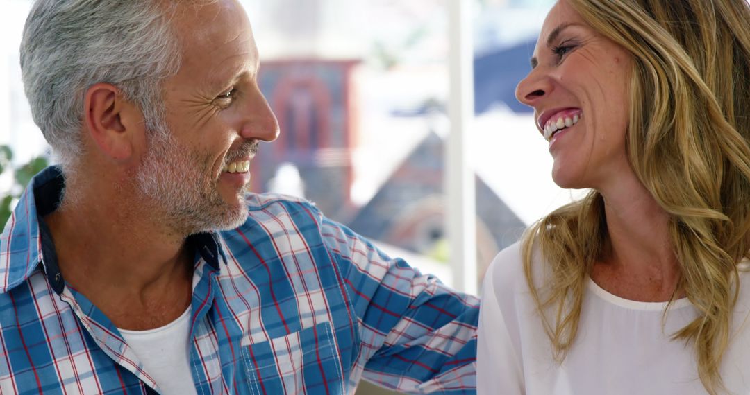 Mature couple is laughing together at home  - Free Images, Stock Photos and Pictures on Pikwizard.com