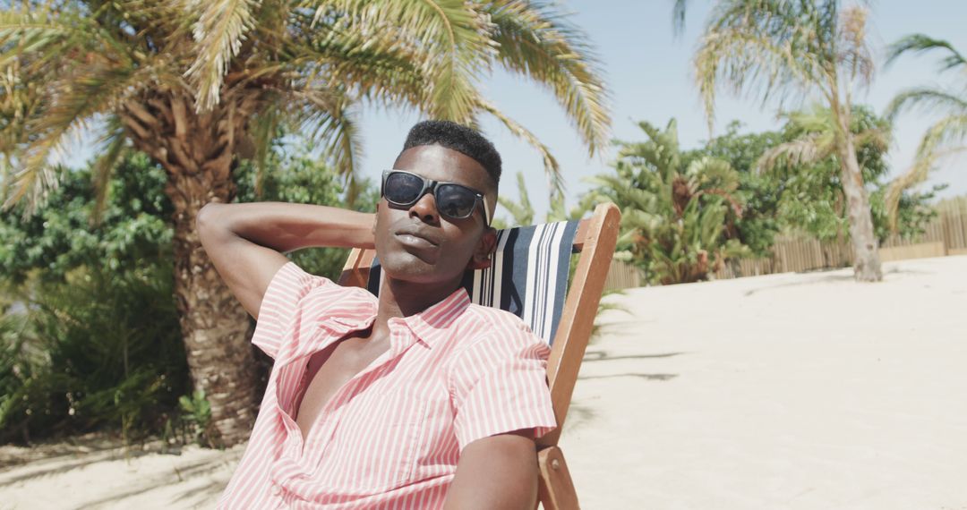 Man Relaxing on Beach in Bright Sunshine - Free Images, Stock Photos and Pictures on Pikwizard.com