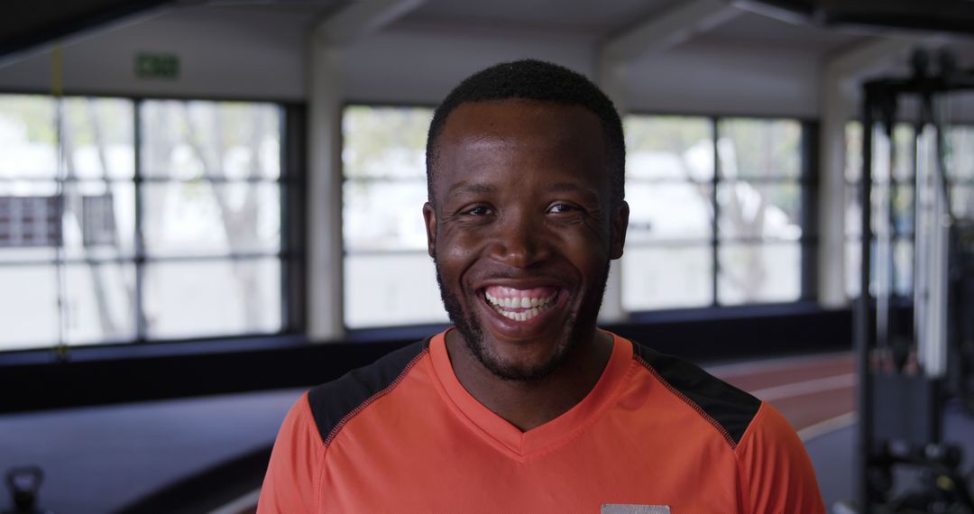 Happy african american athlete smiling in indoor gym facility - Free Images, Stock Photos and Pictures on Pikwizard.com