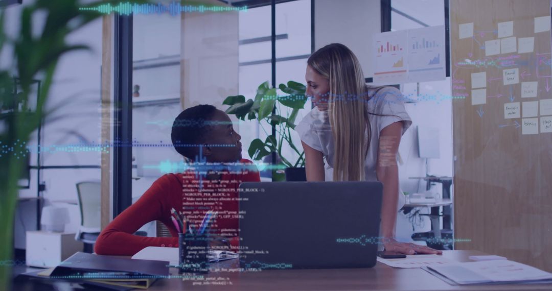 Female Developers Collaborating with Innovative Code Interface in Office