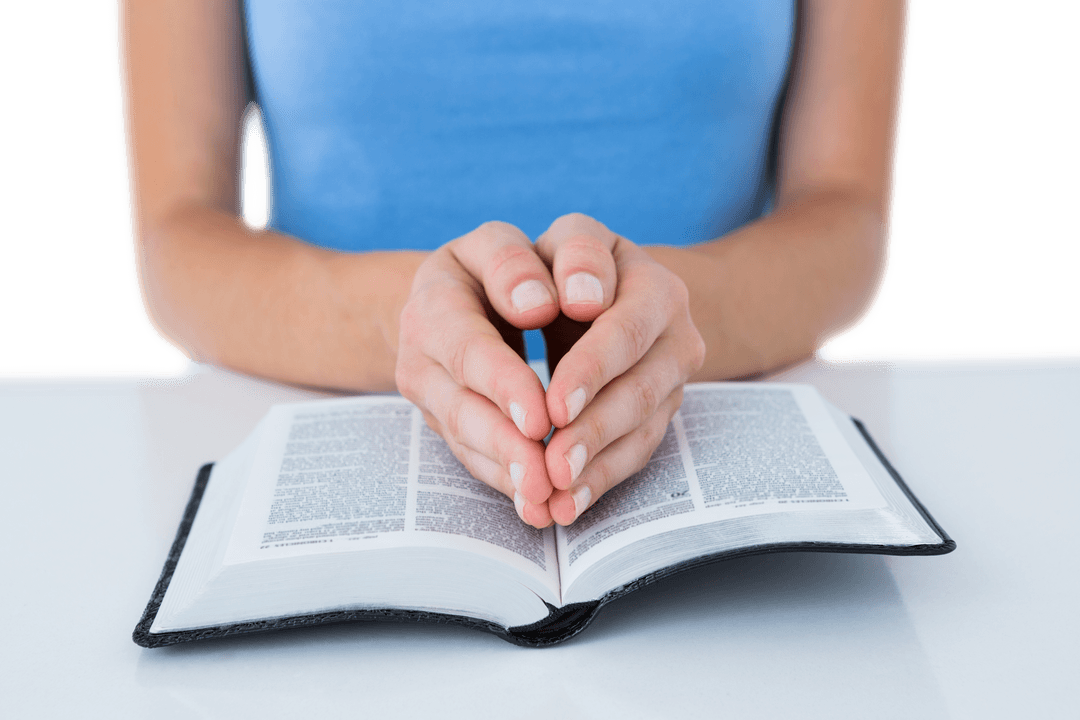 Woman Praying with Bible on White Table, Reflective Moment and Transparent Top