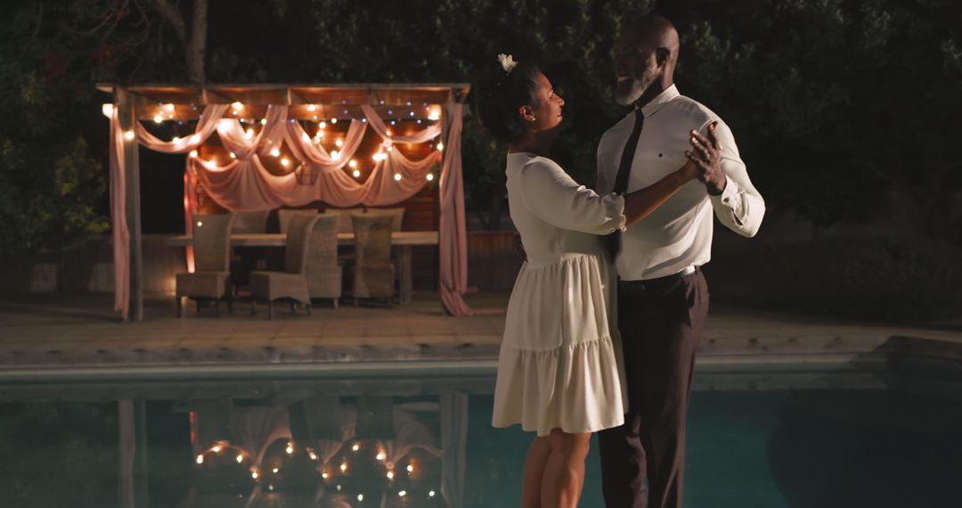 Romantic Couple Dancing by Poolside Under Twinkling Lights