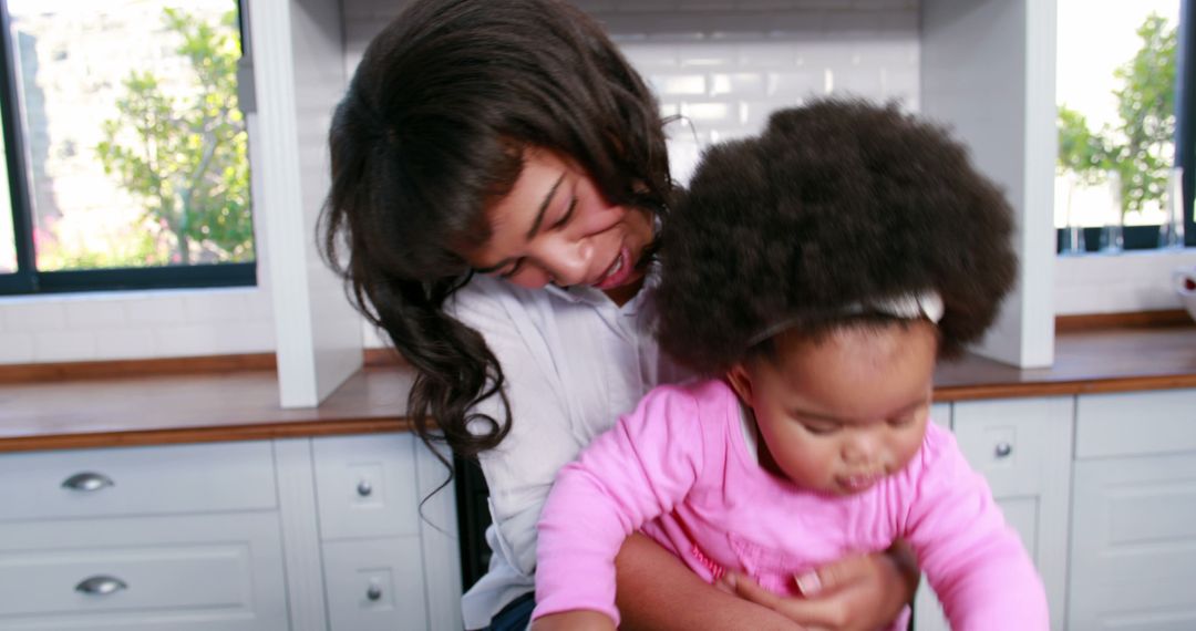 Mother Hugging Toddler in Bright Kitchen for Family Moment - Free Images, Stock Photos and Pictures on Pikwizard.com