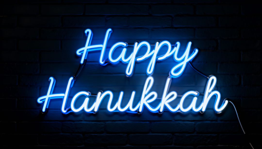 Glowing Blue Neon Happy Hanukkah Script Sign Casting Cyan Light on Dark Brick Wall