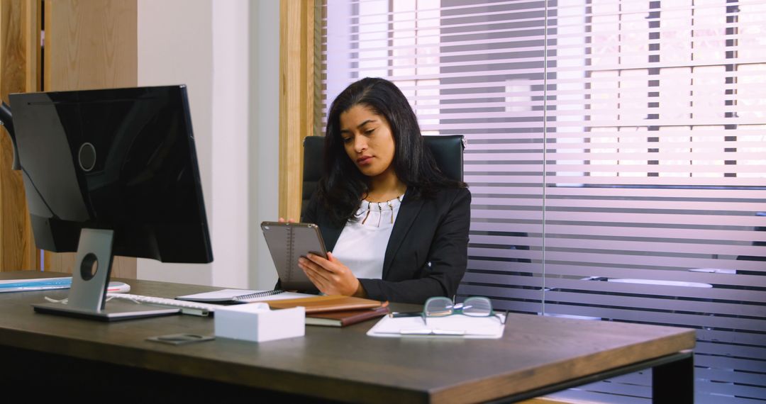 Asian Businesswoman Using Tablet in Modern Office Workspace