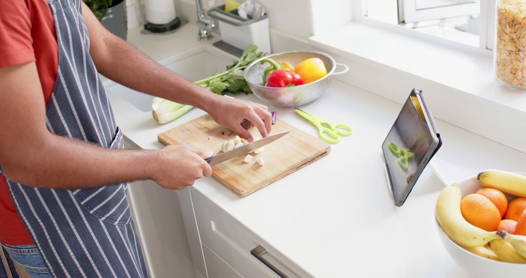 Man Preparing Healthy Meal While Following Recipe On Tablet - Free Images, Stock Photos and Pictures on Pikwizard.com