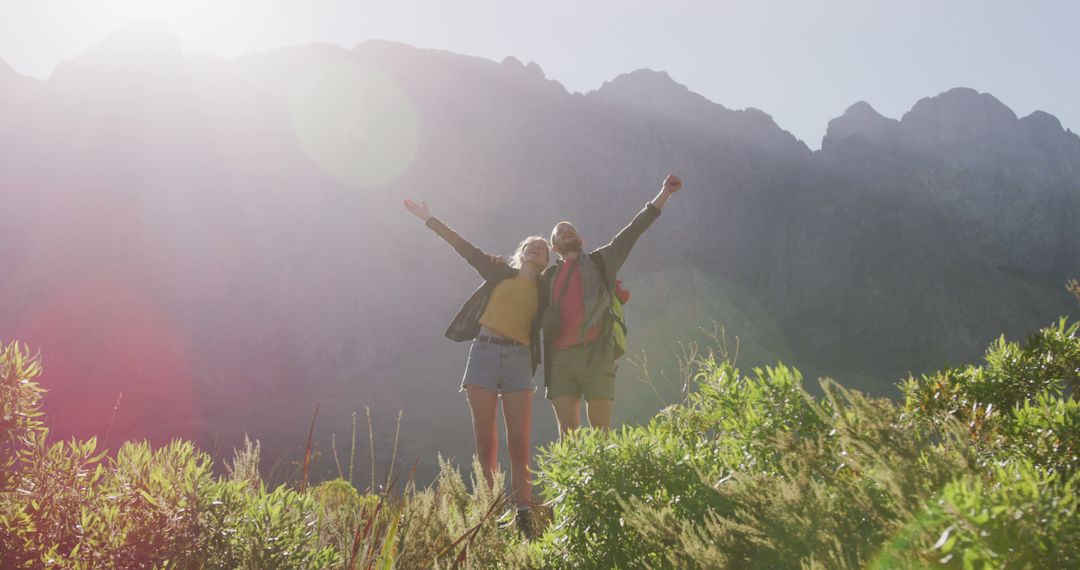 Joyful Couple Hiking in Sunny Mountain Landscape - Free Images, Stock Photos and Pictures on Pikwizard.com