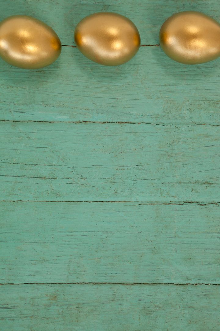 Golden Easter Eggs on Turquoise Wooden Background - Free Images, Stock Photos and Pictures on Pikwizard.com